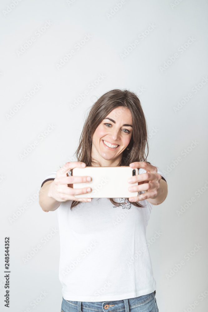 Self portrait of beautiful woman in white background Self portrait of beautiful woman in white background