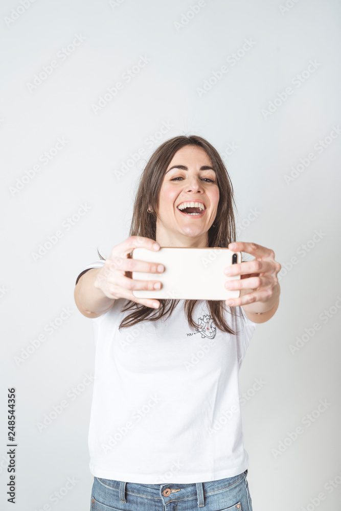 Self portrait of beautiful woman in white background Self portrait of beautiful woman in white background