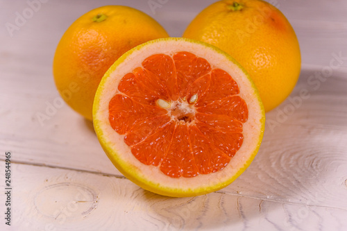 Ripe juicy grapefruit on a white wooden table