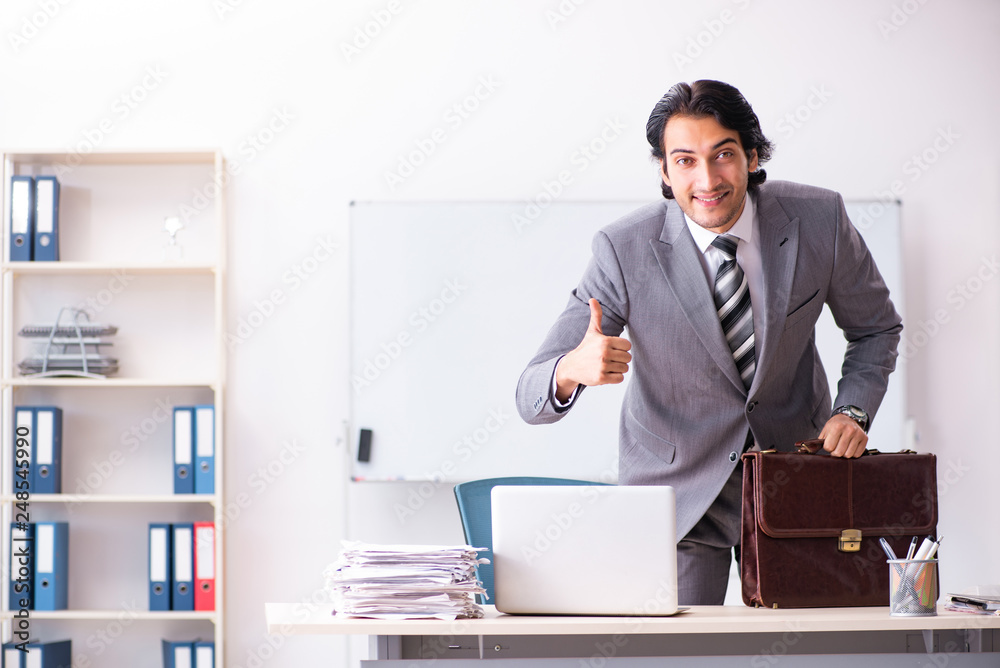 Young handsome businessman employee in the office Young handsome businessman employee in the office
