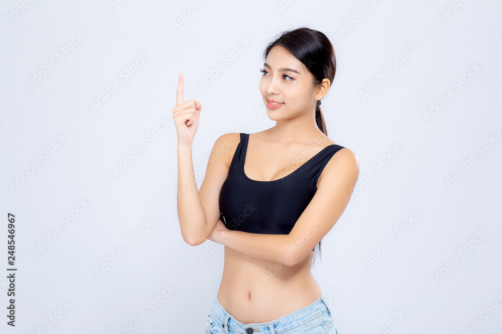 Portrait young asian woman smiling beautiful body diet with fit and finger pointing something isolated on white background, model girl weight slim with cellulite, health and wellness concept. Portrait young asian woman smiling beautiful body diet with fit and finger pointing something isolated on white background, model girl weight slim with cellulite, health and wellness concept.