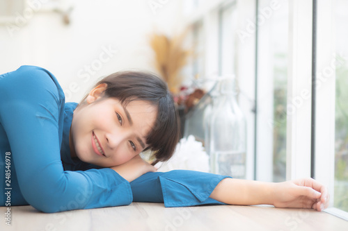 Beautiful portrait young asian woman smiling sitting lying at cafe, model girl happy with relax and resting looking camera, lifestyle concept.