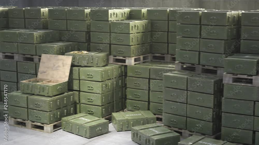 Huge stack of ammo boxes with RPG missiles and rifle ammunition in