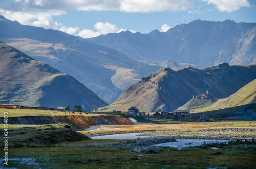 Colourful Truso Valley Gorge view of Ketrisi village and Zakagori fortress, river and mountains in the background photo