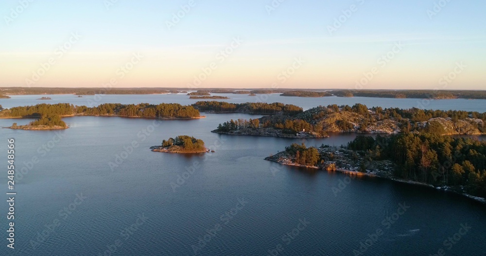 Close to frosty, first snowy islands, at sunset, at the Gulf of Finland, on a sunny, cold, fall evening, Varsinais-suomi, Suomi Close to frosty, first snowy islands, at sunset, at the Gulf of Finland, on a sunny, cold, fall evening, Varsinais-suomi, Suomi