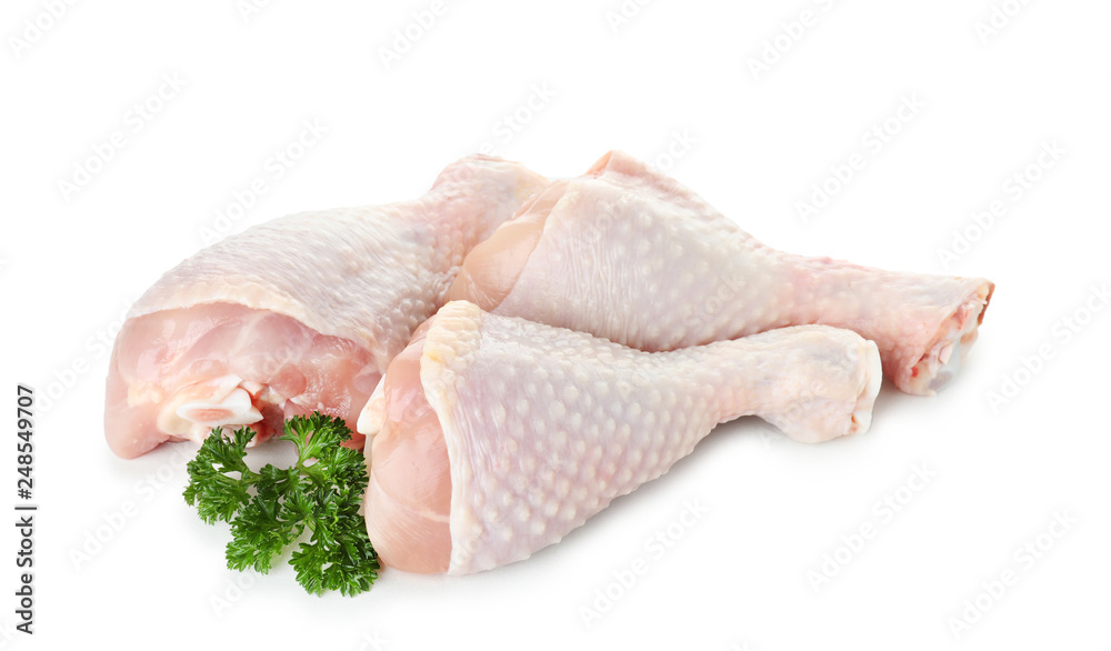 Raw chicken drumsticks with parsley on white background. Fresh meat Raw chicken drumsticks with parsley on white background. Fresh meat