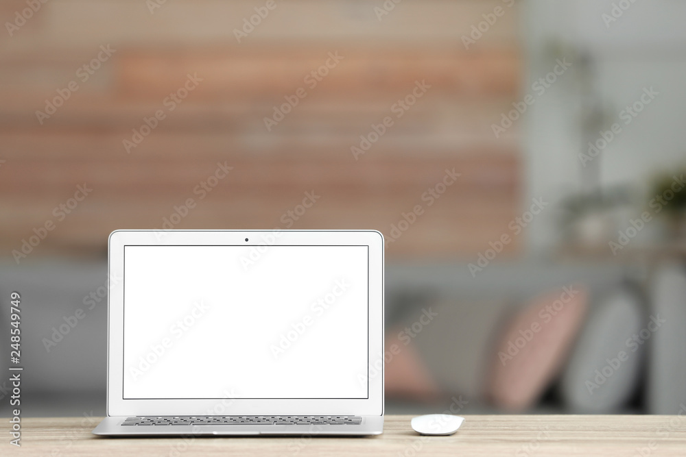 Fototapeta premium Laptop with blank screen on table indoors. Space for text