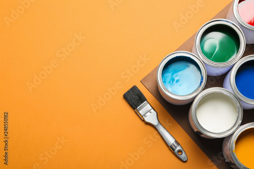 Fototapeta Naklejka Na Ścianę i Meble -  Flat lay composition with paint cans and space for text on color background