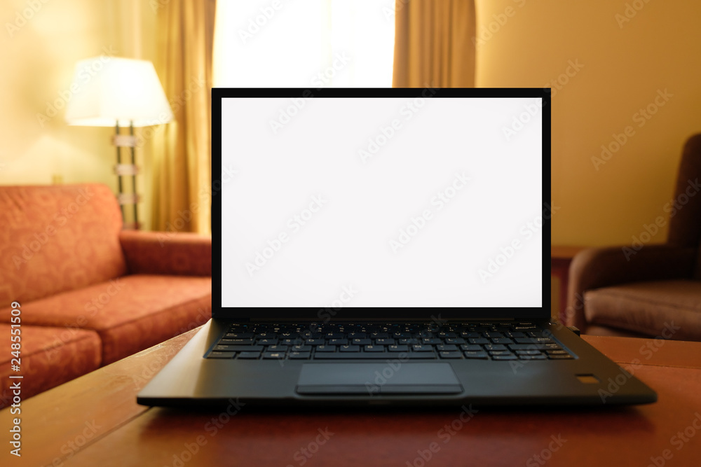 Laptop computer on desk in cozy hotel room with copy space blank screen Laptop computer on desk in cozy hotel room with copy space blank screen