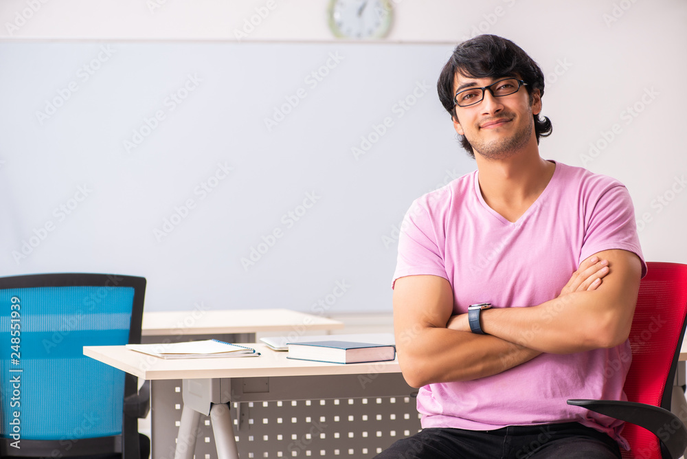 Young male student sitting in the class Young male student sitting in the class