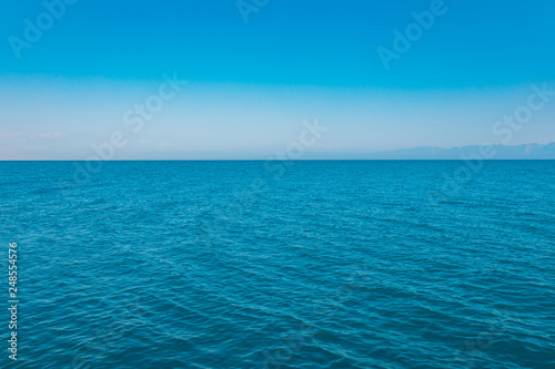 Abstract aqua blue sea and blue sky horizon with ocean surface background. Blue sea water. Summer holiday vacation concept image. Aegean or mediterranean sea.