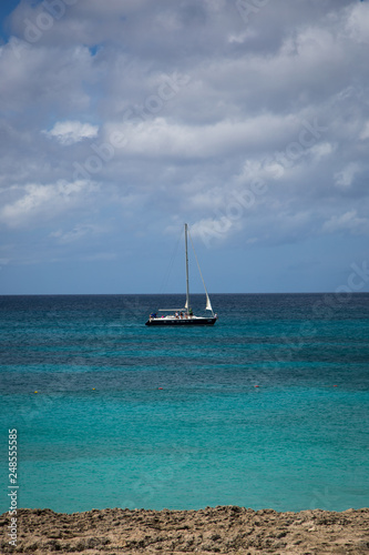 Sailboat cruising by the beach in Aruba