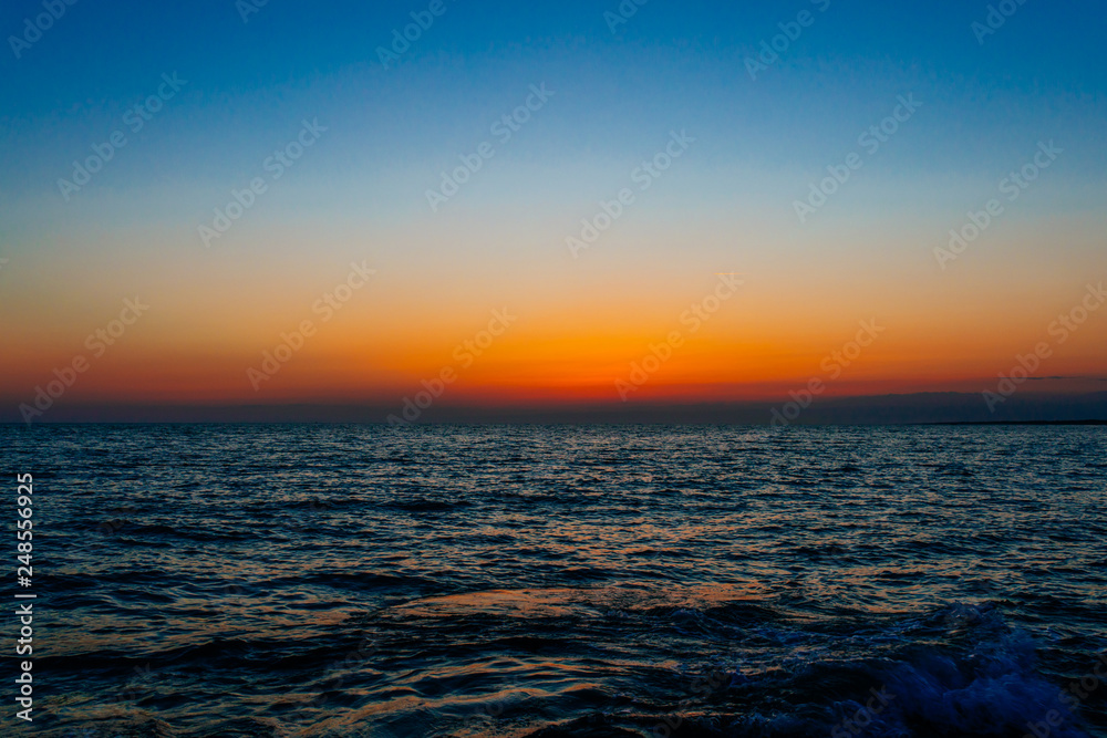 Sunset on the sea or ocean with beautiful blue sky. Sunset or sunrise scene landscape background concept image. Sunset on the sea or ocean with beautiful blue sky. Sunset or sunrise scene landscape background concept image.