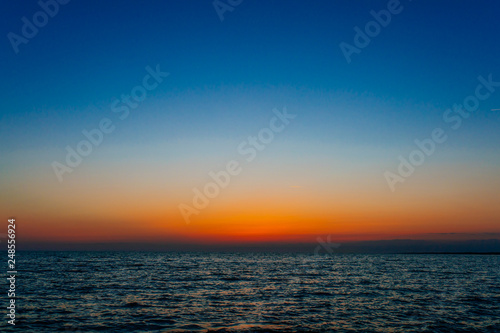 Sunset on the sea or ocean with beautiful blue sky. Sunset or sunrise scene landscape background concept image.