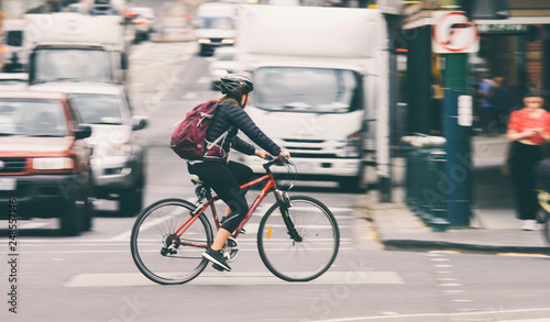 Woman riding bike on city street 