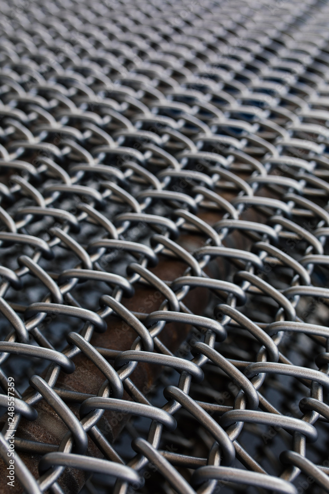 Naklejka premium Metal chain fence seamless texture background texture. Abstract background of steel chain fences. Woven silver metal mesh. Industrial Strength or power concept background image. Metal or steel pattern