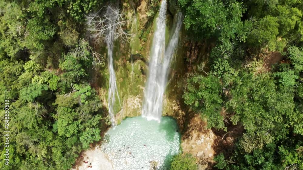 Aerial Descent: People Bathing in Natural Pool under Picturesque Waterfall 
