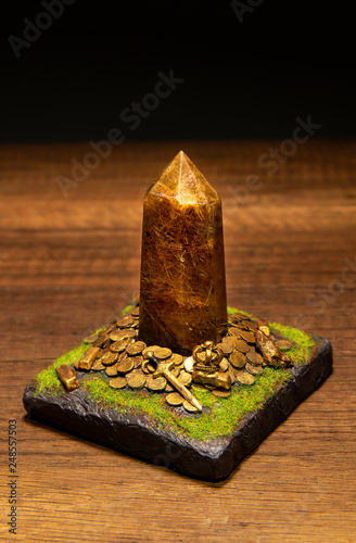 Gold rutilated stone on Treasures and ground