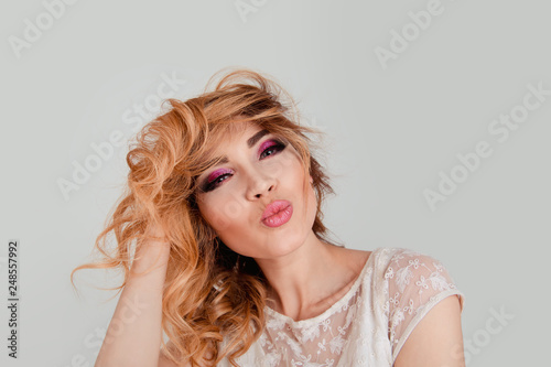 woman sending blowing kiss with pout lips