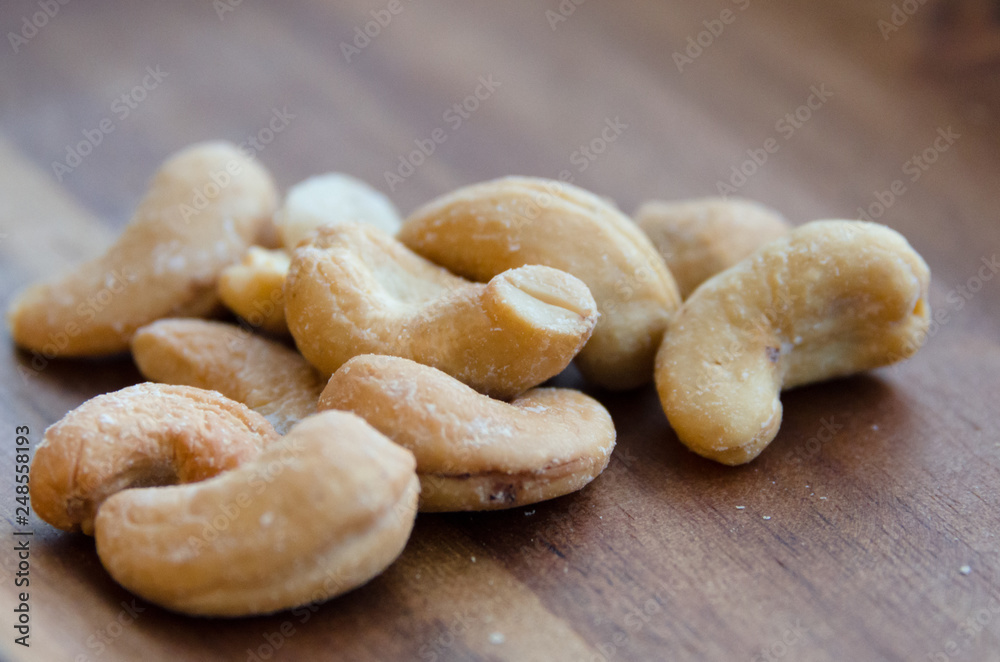 Closeup of cashew nuts on wooden tray Closeup of cashew nuts on wooden tray