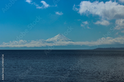 Great lake of blue waters ahead and a Huge mountain with snow is its top