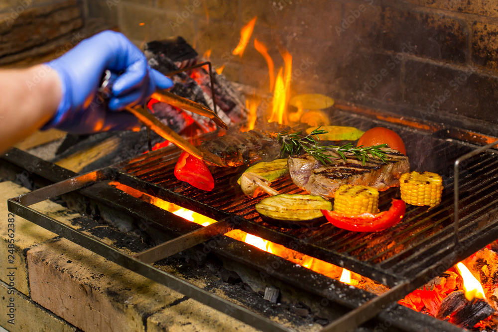 grilled meat and vegetables on an open fire grilled meat and vegetables on an open fire
