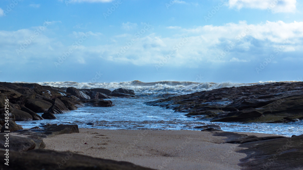 sand, rocks and waves