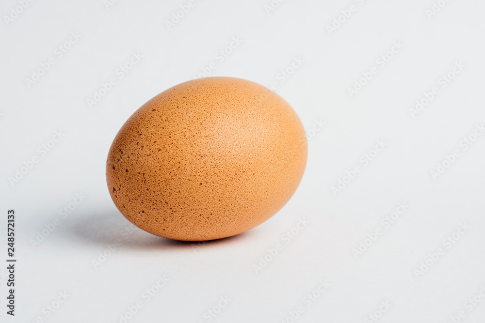 Close-up of fresh egg on white background. Selective focus. Close-up of fresh egg on white background. Selective focus.
