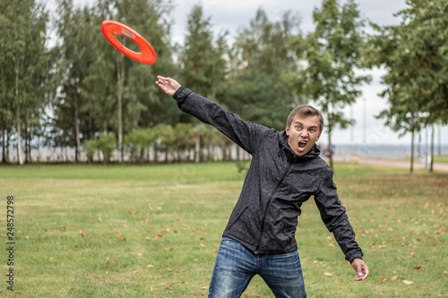 the guy is playing frisbee on the park