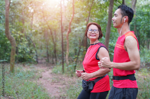 Fototapeta Naklejka Na Ścianę i Meble -   Happy asian mother and son jogging running in the park, Elderly care exercise sport activity concept
