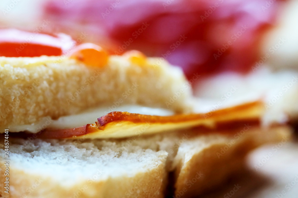 Ham cheese sandwich and tomato ketchup and chili sauce on wood tray and space for write wording, easy delicious food served with coffee or tea in coffee shop or office, popular food for office worker Ham cheese sandwich and tomato ketchup and chili sauce on wood tray and space for write wording, easy delicious food served with coffee or tea in coffee shop or office, popular food for office worker