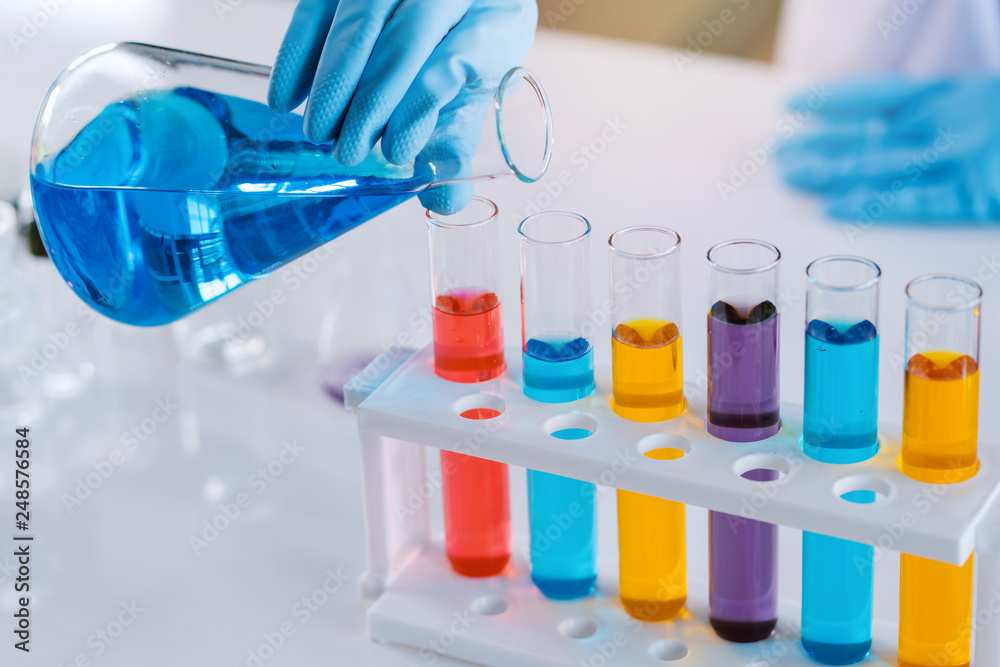 scientist with equipment and science experiments, laboratory glassware containing chemical liquid for research or analyzing a sample into test tube in laboratory scientist with equipment and science experiments, laboratory glassware containing chemical liquid for research or analyzing a sample into test tube in laboratory