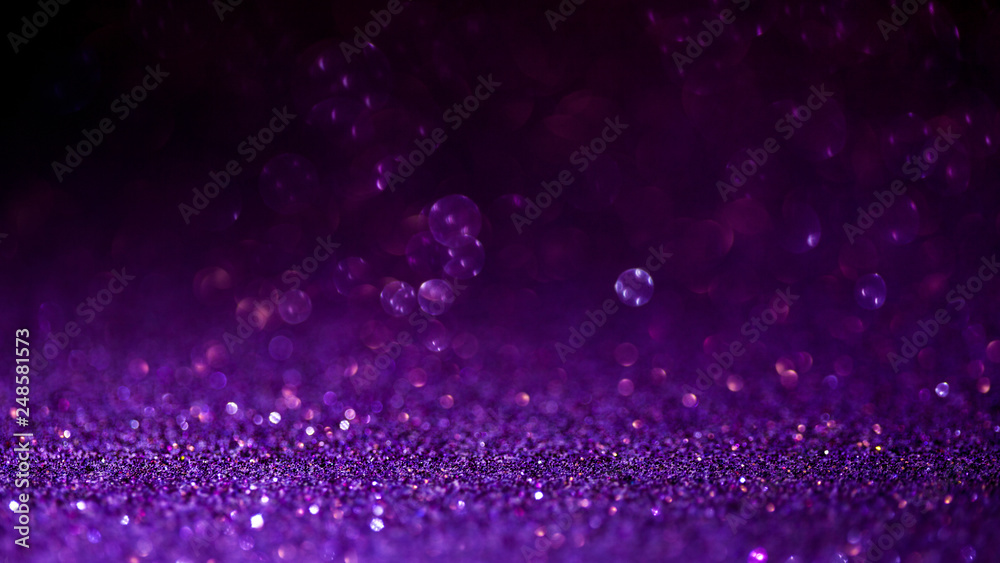 Purple glitter magic background. Defocused light and free focused place for your design.