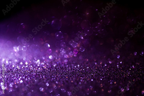Purple glitter magic background. Defocused light and free focused place for your design. © Ulia Koltyrina
