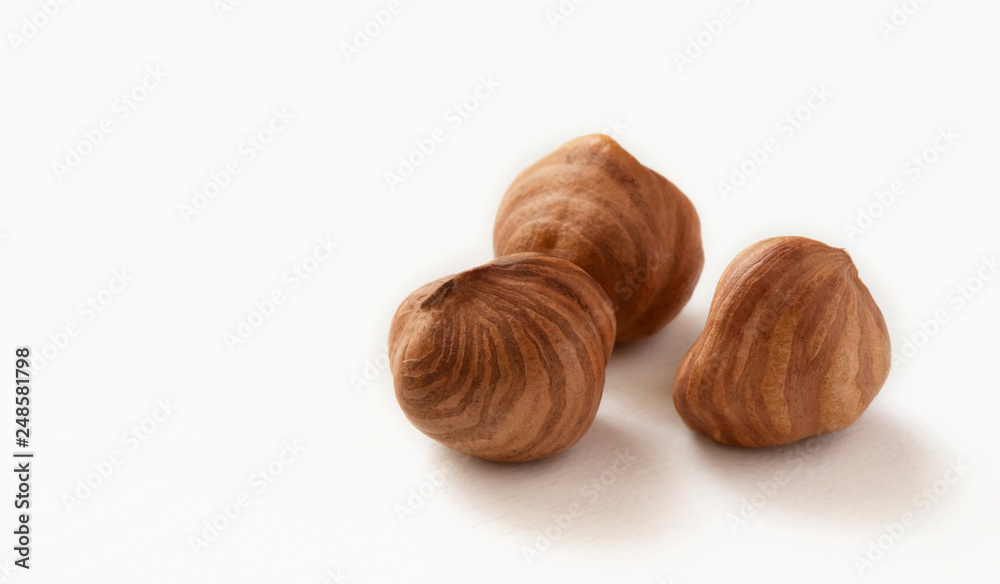 Peeled hazelnut on white table Peeled hazelnut on white table