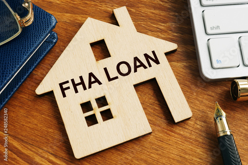 FHA loan written on the model of home. photo