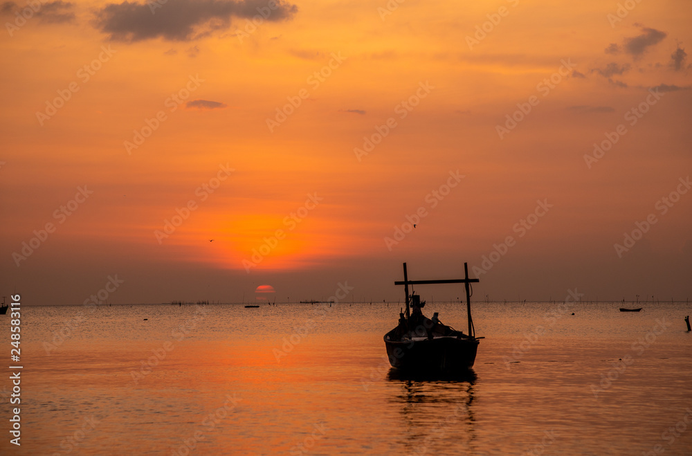 sunset sky with wooden boat.