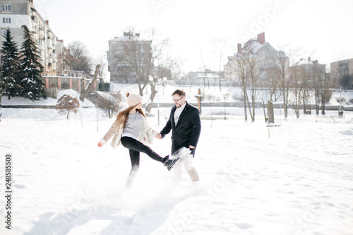 Young Beautiful Couple Taking Fun and Smiling Outdoors in Snowy Winter © andriyyavor