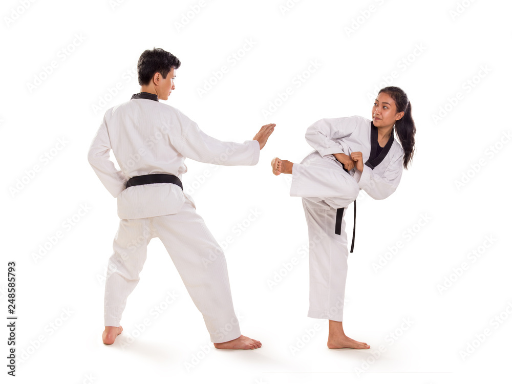 Two young Asian martial art fighters exchanging strikes, full length portrait, isolated background