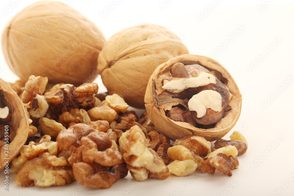 A pile of peeled walnuts at white background A pile of peeled walnuts at white background