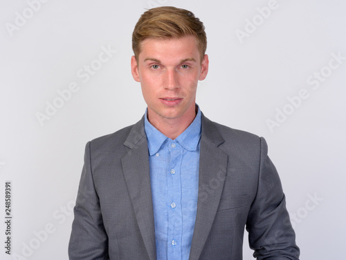 Young handsome businessman with blond hair looking at camera