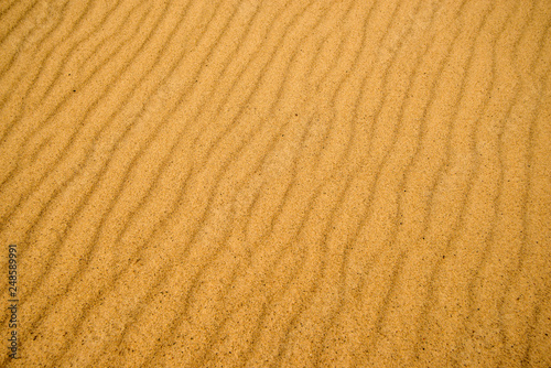 Sand of a beach with wave patterns