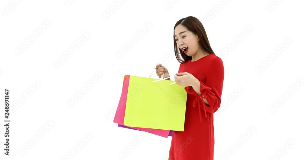 Asian women carry a shopping bags, she moving her body and posts, concept for shopaholic woman, studio shot on white background Asian women carry a shopping bags, she moving her body and posts, concept for shopaholic woman, studio shot on white background