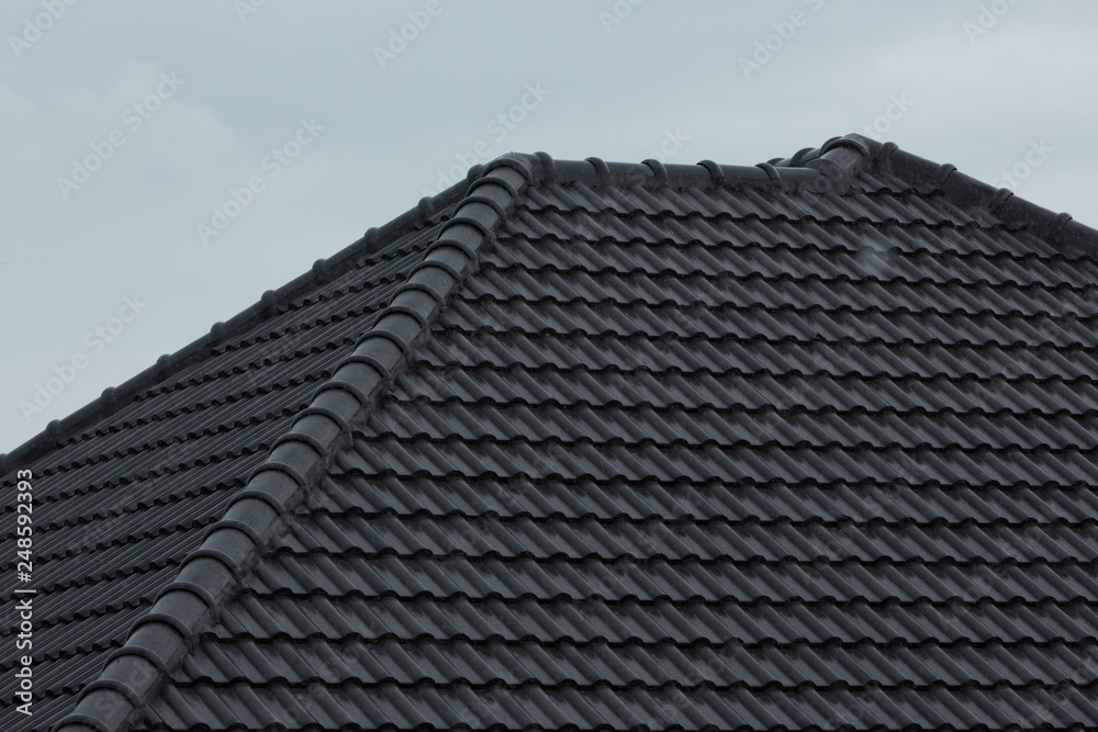 rain storm downpour on black roof tile of residential house rain storm downpour on black roof tile of residential house
