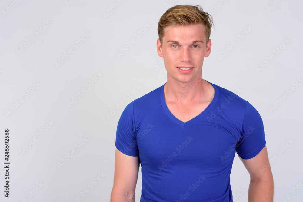 Fototapeta premium Happy young handsome man with blond hair smiling