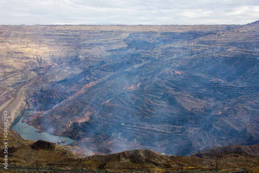 Fototapeta premium Gas pollution of a giant open coalpit