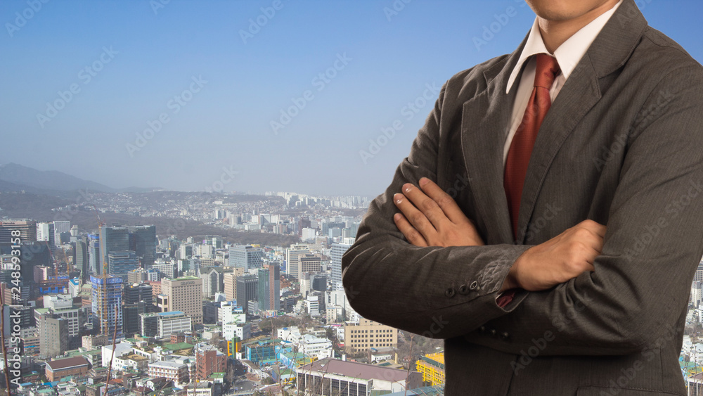 Business man with his arms crossed over big city Business man with his arms crossed over big city