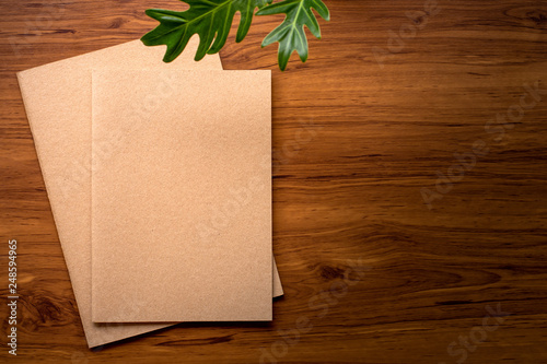 Notebook mock up design template isolated on wooden table background.