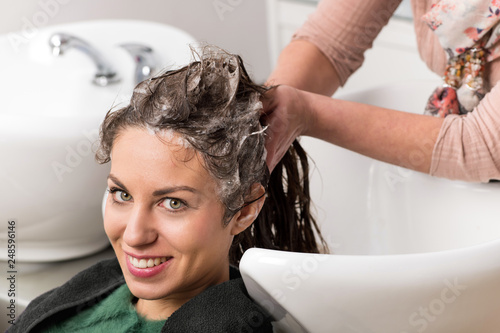 Attractive woman having her hair washed