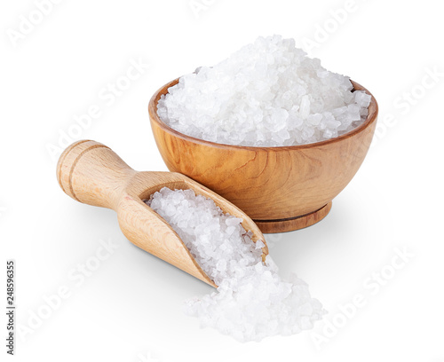 Sea salt crystals in a wooden bowl isolated on white photo
